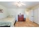 Cozy bedroom features tile flooring, a ceiling fan, ample natural light, and closet access at 1438 E Mesquite St, Gilbert, AZ 85296