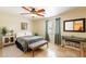 Bedroom features a cozy bed, tile floors, and a ceiling fan at 1438 E Mesquite St, Gilbert, AZ 85296
