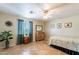 Inviting bedroom with tile flooring, a ceiling fan, ample natural light, and tasteful furnishings at 1438 E Mesquite St, Gilbert, AZ 85296