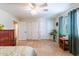Spacious bedroom boasts tile flooring, a ceiling fan, lots of natural light, and closet storage at 1438 E Mesquite St, Gilbert, AZ 85296