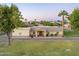 Sprawling single-story home with large lawn, desert landscaping, and stone accents on the facade at 1438 E Mesquite St, Gilbert, AZ 85296
