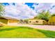 Spacious ranch home with an attached three car garage, lush lawn and landscaping at 1438 E Mesquite St, Gilbert, AZ 85296