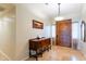 Foyer featuring wooden front door, tiled flooring, a chandelier, and dark wood furniture at 1438 E Mesquite St, Gilbert, AZ 85296