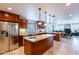 Open-concept kitchen features stainless steel appliances, granite counters, a center island, and adjoins the living area at 1438 E Mesquite St, Gilbert, AZ 85296