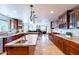 Large kitchen featuring custom cabinetry, granite countertops, a wine rack, and stainless steel appliances at 1438 E Mesquite St, Gilbert, AZ 85296