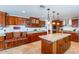 Gourmet kitchen featuring granite countertops, custom cabinets with wine rack, and stainless steel appliances at 1438 E Mesquite St, Gilbert, AZ 85296