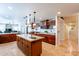 Spacious kitchen boasts granite countertops, a large island with seating, and wood cabinetry at 1438 E Mesquite St, Gilbert, AZ 85296