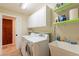 Functional laundry room with washer, dryer, sink, shelving, and storage cabinets at 1438 E Mesquite St, Gilbert, AZ 85296