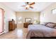 Spacious bedroom with a ceiling fan, tan walls, tile flooring, and lots of natural light from the large windows at 1438 E Mesquite St, Gilbert, AZ 85296