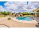 Backyard pool featuring sun umbrellas, desert landscaping, and an open view of the house at 1438 E Mesquite St, Gilbert, AZ 85296