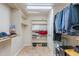 Spacious walk-in closet with built-in shelves and racks, offering plenty of storage space at 1438 E Mesquite St, Gilbert, AZ 85296