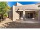 The backyard features a covered patio, desert landscaping, and multiple sliding glass door access points at 14458 W Zuni Trl, Surprise, AZ 85374