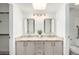 Bright bathroom featuring a dual sink vanity with granite countertops and modern fixtures at 14458 W Zuni Trl, Surprise, AZ 85374