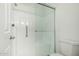 Updated bathroom features a glass door shower, grab bar, and white fixtures at 14458 W Zuni Trl, Surprise, AZ 85374