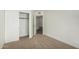 Neutral carpeted bedroom with closet and entrance to another room at 14458 W Zuni Trl, Surprise, AZ 85374