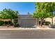 Charming single-story home featuring mature trees and a neutral-toned exterior at 14458 W Zuni Trl, Surprise, AZ 85374