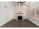 Bright living room with fireplace, high ceilings, neutral walls, and shuttered windows at 14458 W Zuni Trl, Surprise, AZ 85374