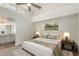 Serene main bedroom features high ceilings, a ceiling fan, and an ensuite bath at 14458 W Zuni Trl, Surprise, AZ 85374