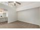 This main bedroom features an ensuite bathroom and modern ceiling fan at 14458 W Zuni Trl, Surprise, AZ 85374