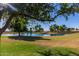 Scenic view of a lush community pond surrounded by a well-maintained golf course at 14458 W Zuni Trl, Surprise, AZ 85374
