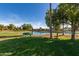 Well-maintained community pond situated alongside a beautifully green golf course at 14458 W Zuni Trl, Surprise, AZ 85374