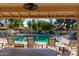 View of sparkling community pool with lounge chairs and tables, perfect for relaxation and social gatherings at 14458 W Zuni Trl, Surprise, AZ 85374