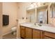 Well-lit bathroom with a vanity, mirror, and a view into the shower at 14950 W Mountain View Blvd # 7309, Surprise, AZ 85374