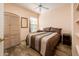 Comfortable bedroom with a ceiling fan and a cozy bed at 14950 W Mountain View Blvd # 7309, Surprise, AZ 85374