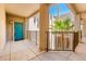 Exterior walkway to teal doors surrounded by lush greenery and landscaping at 14950 W Mountain View Blvd # 7309, Surprise, AZ 85374