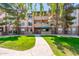 Beautifully landscaped building exterior with a walkway leading to the entrance and mature trees at 14950 W Mountain View Blvd # 7309, Surprise, AZ 85374