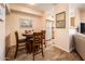 Dining area with round table and chairs adjacent to a kitchen and living area at 14950 W Mountain View Blvd # 7309, Surprise, AZ 85374