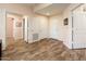 Inviting hallway with wood flooring, neutral walls, and multiple doors for easy access at 14950 W Mountain View Blvd # 7309, Surprise, AZ 85374