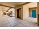 Well-maintained hallway with an elevator and bright teal doors to individual apartments at 14950 W Mountain View Blvd # 7309, Surprise, AZ 85374