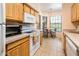 Bright kitchen with stainless steel appliances, wood cabinets, and a sunny breakfast nook at 14950 W Mountain View Blvd # 7309, Surprise, AZ 85374