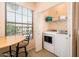 Bright laundry area featuring a window, shelving, and modern washer and dryer at 14950 W Mountain View Blvd # 7309, Surprise, AZ 85374