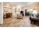 Open-concept living room with wood-look floors, a ceiling fan, and a balcony entrance at 14950 W Mountain View Blvd # 7309, Surprise, AZ 85374