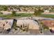 A stunning aerial view showcases this home, beautifully landscaped, and a three-car garage at 15109 W Waterford Dr, Surprise, AZ 85374