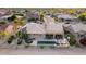 Discover a home with a sparkling pool, spa, lush landscaping, and covered patio from above at 15109 W Waterford Dr, Surprise, AZ 85374