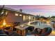 This backyard features a cozy fire pit and pool, perfect for outdoor entertaining at 15109 W Waterford Dr, Surprise, AZ 85374