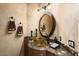 Half-bath with vessel sink, marble countertops, and custom finishes throughout at 15109 W Waterford Dr, Surprise, AZ 85374