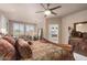 Large bedroom features a ceiling fan, neutral walls, and a seating area with lots of natural light at 15109 W Waterford Dr, Surprise, AZ 85374