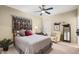 Cozy bedroom featuring a comfortable bed, decorative artwork, and natural light from the window at 15109 W Waterford Dr, Surprise, AZ 85374