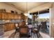 Breakfast nook features natural lighting from the sliding glass door, wood cabinets, and stone backsplash at 15109 W Waterford Dr, Surprise, AZ 85374