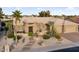 Expansive exterior view featuring desert landscaping, a spacious driveway, and a two-car garage at 15109 W Waterford Dr, Surprise, AZ 85374