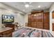 Well-lit flex room features built-in cabinetry, a queen Murphy bed, and a large decorative rug at 15109 W Waterford Dr, Surprise, AZ 85374