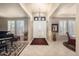 Elegant foyer featuring high ceilings, tile flooring, and natural light streaming through shuttered windows at 15109 W Waterford Dr, Surprise, AZ 85374