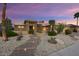 Inviting front exterior with desert landscaping and stone accents, showing a charming entrance at 15109 W Waterford Dr, Surprise, AZ 85374