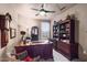 Elegant home office featuring a large desk, built-in bookcase, and comfortable seating at 15109 W Waterford Dr, Surprise, AZ 85374