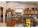 Well-lit kitchen with stainless steel appliances, granite countertops, and custom wood cabinetry at 15109 W Waterford Dr, Surprise, AZ 85374