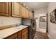 Bright laundry room with a sink, modern washer/dryer, and plenty of cabinet space at 15109 W Waterford Dr, Surprise, AZ 85374